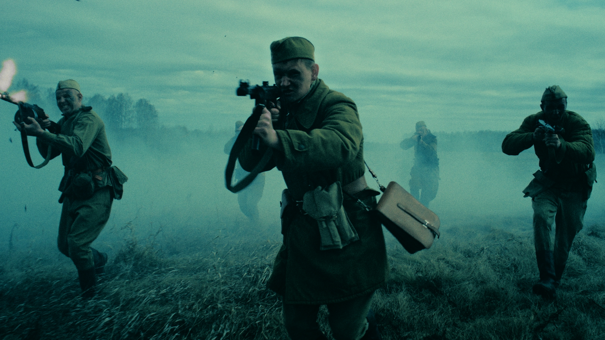 Three soldiers in military gear with rifles in a foggy landscape